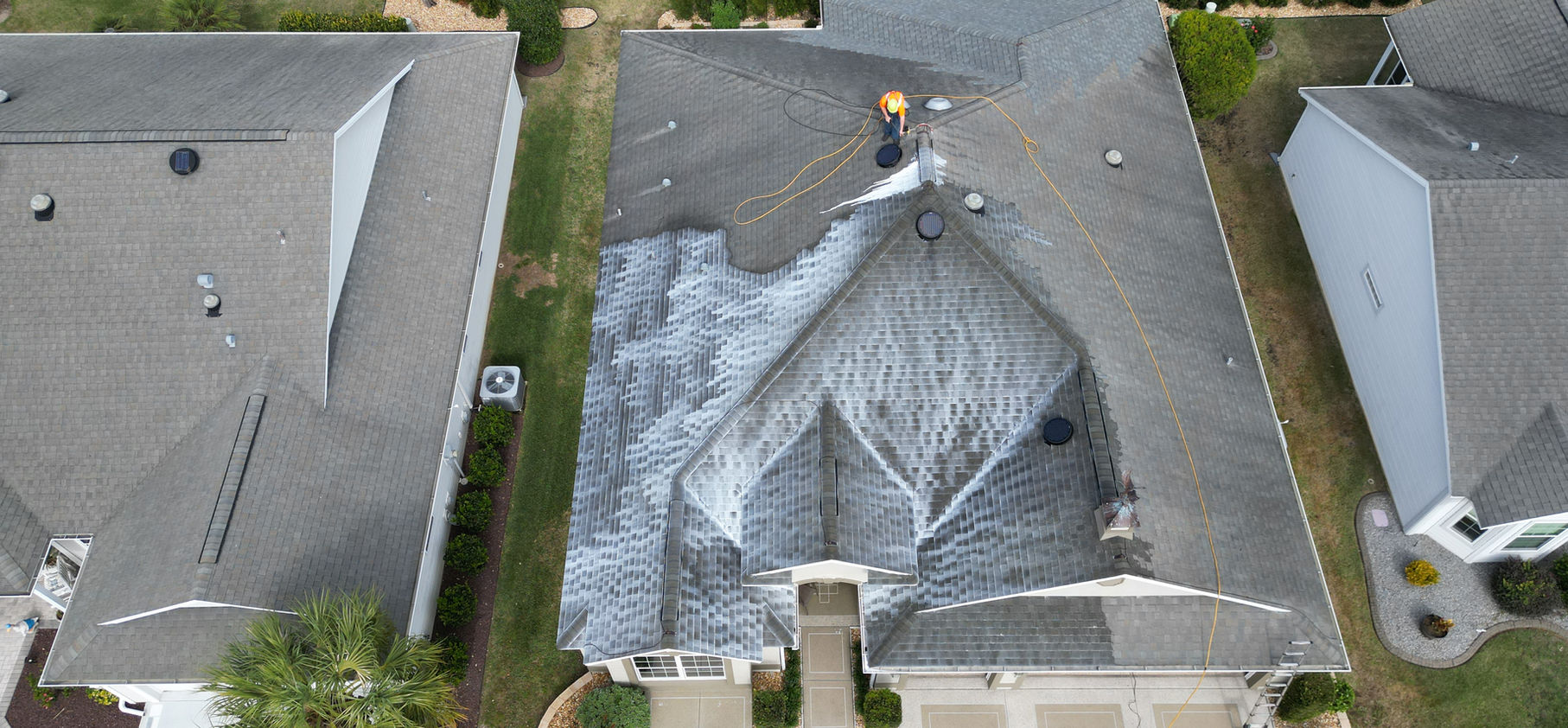 Aerial view of roof rejuvenation treatment in progress